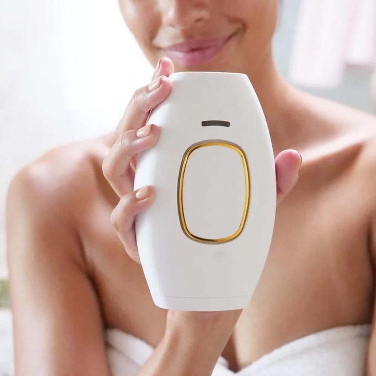 Person holding a white electronic device with a gold accent